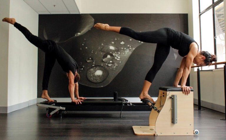 a young couple doing pilates at home