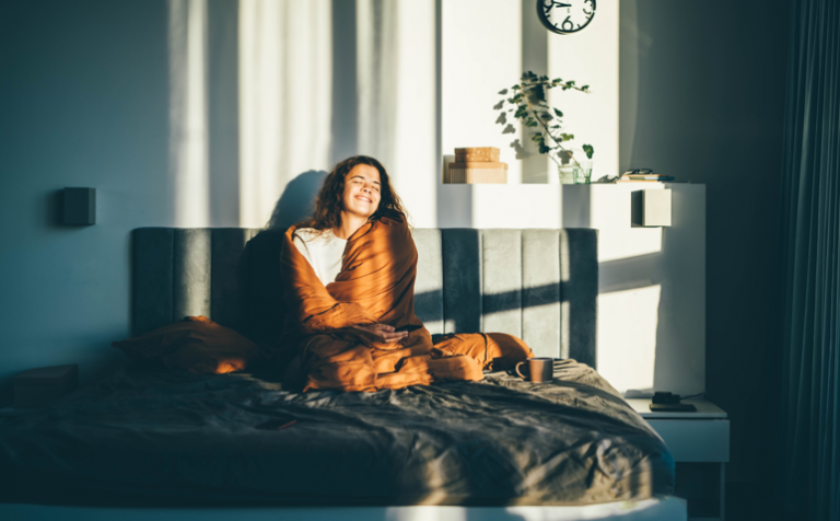 a happy lady in bed as she just woke up