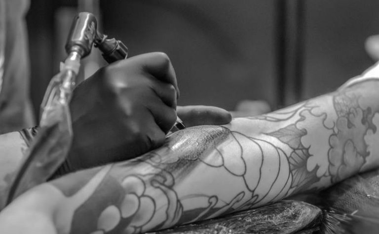 a guy getting tattooed