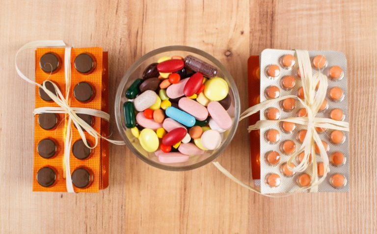 Colorful medical pills and capsules for therapy and blisters of tablets or supplements, concept of treatment and health care