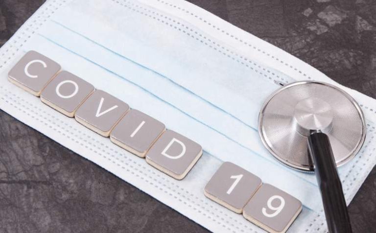 Inscription covid-19 with surgical or protective mask and stethoscope. Novel Chinese coronavirus outbreak. 2019-nCoV. Sars-CoV-2