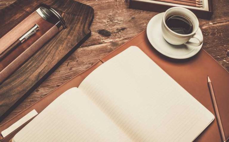 Luxurious writing tools on a wooden table
