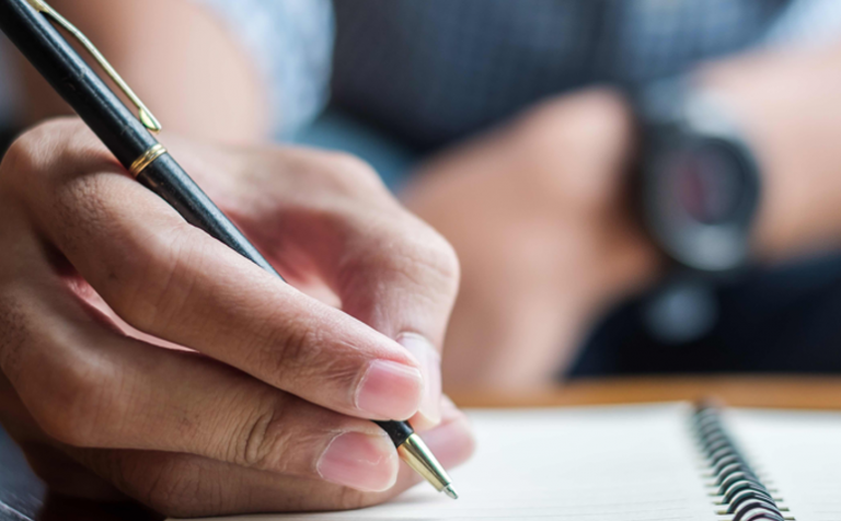man writing a letter